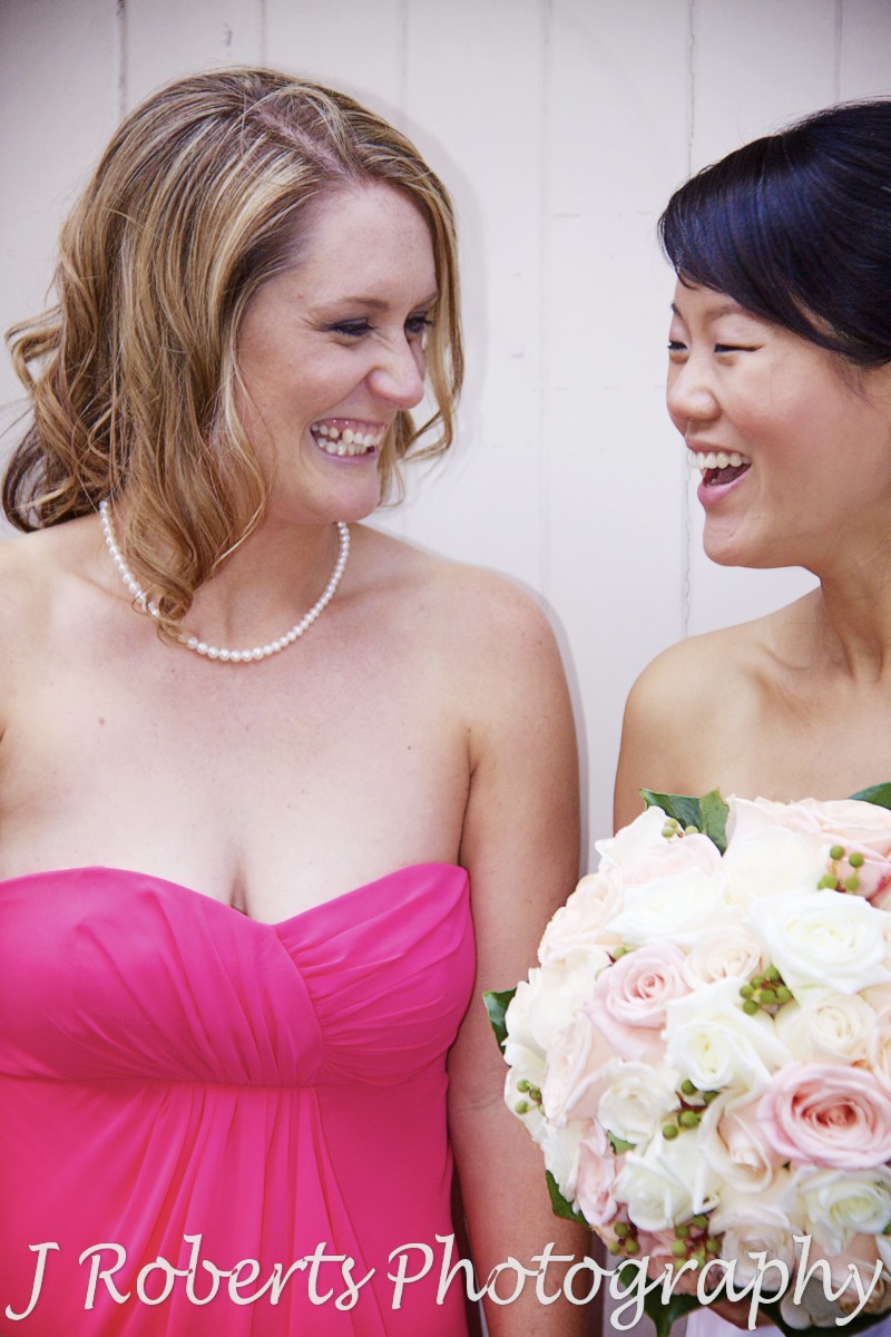 Bride and bridesmaid laughing - wedding photography sydney